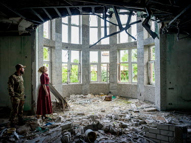 Natalia Voronkova, a volunteer who offers support and basic first aid training for Ukrainian government forces fighting Russian-backed separatists in the east of the country, visits a damaged summer r...