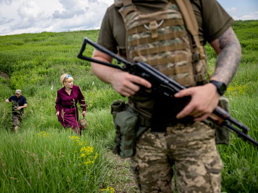 Natalia Voronkova, a volunteer who offers support and basic first aid training for Ukrainian government forces fighting Russian-backed separatists in the east of the country, walks with soldiers near...