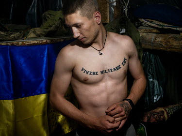 Andre, a Ukranian government soldier, inside the underground bunker where the soldiers sleep and can take cover when they are under bombardment, which happens on a daily basis.