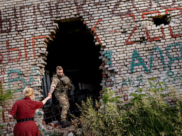 Natalia Voronkova, a volunteer who offers support and basic first aid training for Ukrainian government forces fighting Russian-backed separatists in the east of the country, visits a damaged former s...