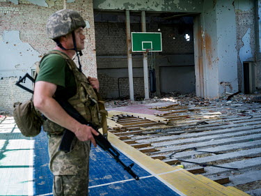 A Ukrainian government soldier stands inside the gym of a former boarding school which is now on the frontline with Russian-backed seperatist fighters. Ukrainian government soldiers have taken up posi...