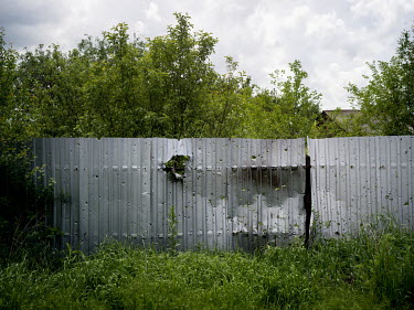 Shrapnel marks on a metal fence in a residenial area of Marinka which according to Ukrainian government forces was a result of mortar fire from Russian-backed separatists from the positions they hold...