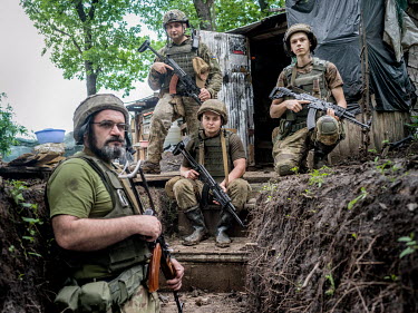 Vladimir (left), with other Ukrainian government soldiers, at their position near the town of Krasnotiorivke. The enemy, Russian-backed separatists, are in their positions only a few hundred metres aw...