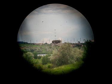 The frontline positions of Russian-backed separatists, seen through a periscope from the Ukrainian government force's position. The separatists are hidden in this building only a few hundred metres aw...