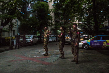 Soldiers guard a street as the military open up a local administration office that had been closed by anti-coup protestors to prevent a junta-appointed local administration in their neighbourhood in T...