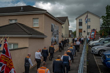 Orangemen march through the Loyalist Fountain estate on the 12th July when some members of the Protestant community celebrate the defeat of the Catholic Army at the Battle of the Boyne in 1690.