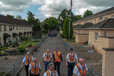 UK. Derry/ Londonderry. 12th July 2021  An Orange parade through the Loyalist Fountain estate in Derry/Londonderry.  Andrew Testa for the New York Times