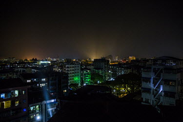 People in a neighbourhood flash torches and mobile phone lights from their apartments as they participate in a 'hashtag flash strike' campaign to protest against the military coup.