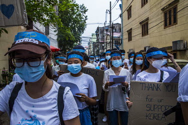 In a flashmob protest against the military coup, youth demonstrators wear headbands with the slogan 'R2P' (Responsbility to Protect) and hold signs thanking other countries who have shown support towa...