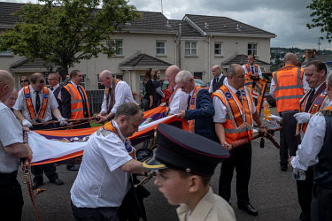 Orangemen pack away their banners after parading through the city.