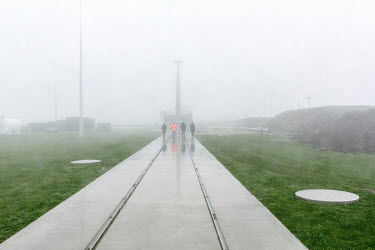 Staff walk through the rain at Rocket Lab's Launch Complex 1, the world's first private orbital launch range. The FAA compliant site can accommodate a launch rate of 120 flights per year and is licens...
