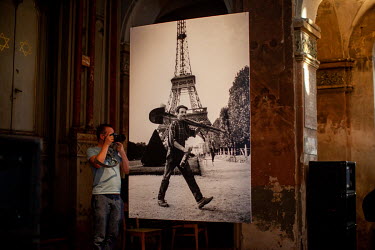 A visitor takes a picture at a memorial exhibition forProfessor Pavel Dias at the Palmovka Synagogue. Pavel Dias, photographer and university teacher, died at the age of 82 in April 2021.