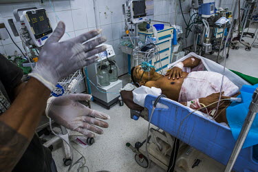 U Kyaw Lwin Tun (43) arrived at the hospital with a wound in the abdomen which exposed internal organs, which he believed is from a gunshot but doctors think it could have resulted from a blast. Here...