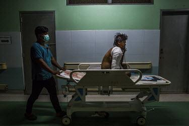 An injured protestor is transported on a trolly, at the emergency ward at a hospital where a group of government medical officers participating in the Civil Disobedience Movements (CDM) discreetly tre...