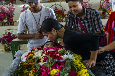 A relative kisses the dead body of Ma Khine Zar Thwe (25), a bank worker, who was shot and killed on 28 March 2021 amid a protest crackdown in South Dagon township, at her funeral.
