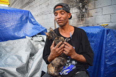 Anthony, a homeless veteran who who has a job, with his cat.  Thousands of homeless people camp out in the centre of Los Angeles, in an area of about 50 blocks. In greater Los Angeles, there are 70,00...