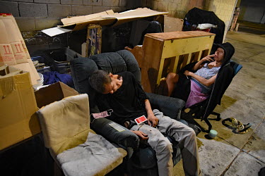 A homeless man sleeping in an arm chair.  Thousands of homeless people camp out in the centre of Los Angeles, in an area of about 50 blocks. In greater Los Angeles, there are 70,000 homeless people, w...