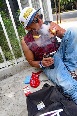 Sunny, a homeless man of Korean descent, smokes a pipe of crystal meth.  Thousands of homeless people camp out in the centre of Los Angeles, in an area of about 50 blocks. In greater Los Angeles, ther...