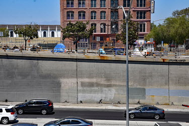 Homeless people's tents line a road above a highway. Thousands of homeless people camp out in the centre of Los Angeles, in an area of about 50 blocks. In greater Los Angeles, there are 70,000 homele...