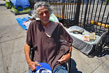 A homeless man wearing a top with 'L A County Jail' printed on it.  Thousands of homeless people camp out in the centre of Los Angeles, in an area of about 50 blocks. In greater Los Angeles, there ar...