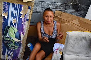 Nancy, a homeless person originally from from Missouri, smokes crystal meth while sitting in her cardboard shelter.  Thousands of homeless people camp out in the centre of Los Angeles, in an area of a...