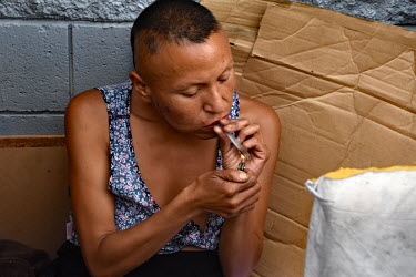 Nancy, a homeless person originally from from Missouri, smokes crystal meth while sitting in her cardboard shelter.  Thousands of homeless people camp out in the centre of Los Angeles, in an area of a...