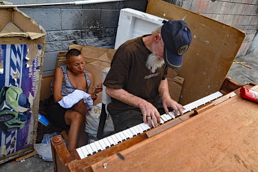 Nancy, a homeless person originally from from Missouri, smokes crystal meth while Rodney, a man from Ohio who used to be a prtofessional musician, plays Hotel California on a discarded piano.  Thousan...