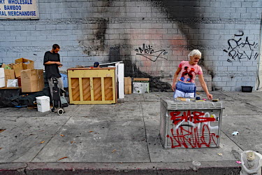A homeless person sorts through her possessions.  Thousands of homeless people camp out in the centre of Los Angeles, in an area of about 50 blocks. In greater Los Angeles, there are 70,000 homeless p...
