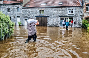 People using sandbags to try and protect a house from flood waters after heavy rain caused the River Lomme to burst its banks.