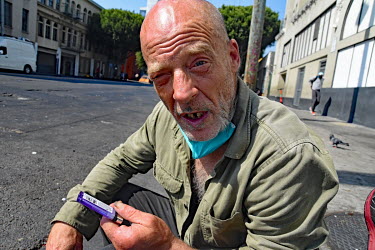 Scotty, a homeless crystal meth addict sits on the pavement on San Pedro street.  Thousands of homeless people camp out in the centre of Los Angeles, in an area of about 50 blocks. In greater Los Ange...