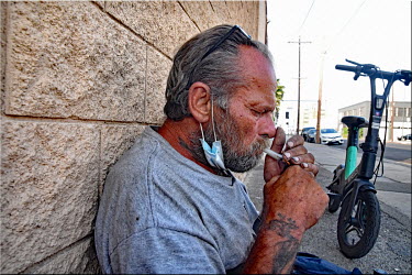 Rodney, a homeless man, smokes a pipe of crack.  Thousands of homeless people camp out in the centre of Los Angeles, in an area of about 50 blocks. In greater Los Angeles, there are 70,000 homeless p...