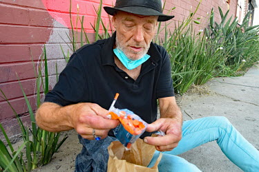 Scotty, a homeless crystal meth addict, who says he 'slams three dimes of meth a day', street slang for injecting 30 USD of crystal meth. He makes money selling items such as needles, given out by cha...
