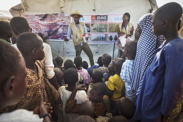 Sherriff Gana Bama, a community liaison team leader with MAG (Mines Advisory Service) talks to children in a camp for IDPs about risks from mines and IEDs. He says: 'I am so happy to be working with M...