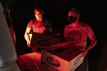 Police officers load boxes of illegally harvested wild conopytums into a truck after a sting operation in the desert near Steinkopf. The plants are at the centre of a massive wave of plant poaching th...