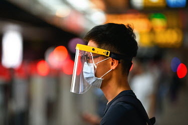 A main wearing a face mask and a visor while travelling on the Taipei MRT system during 'Level 3' period of heightened alertness due to a recent rise in COVID-19 cases in Taiwan, mostly occuring in th...