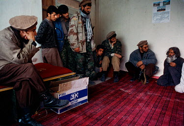 Commander Ahmad Shah Massoud (The Lion of Panjshir) (L) and some of his mujahideen interrogate a captured fighter from the Taliban forces attacking Taloqan.