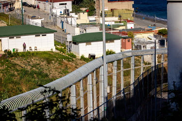 The border fence between the Spanish exclave of Ceuta and Morocco in the Benzou district.