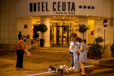 People walking their dogs at night in city centre in the Spanish exclave of Ceuta.