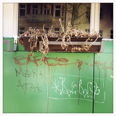 Neglected flowers on a balcony in Moabit.  The Berlin district of Moabit is an artificial island completely surrounded by water that was once home to various industries and staunchly working-class . H...