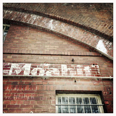 A painted Moabit sign on a wall.  The Berlin district of Moabit is an artificial island completely surrounded by water that was once home to various industries and staunchly working-class . However,...
