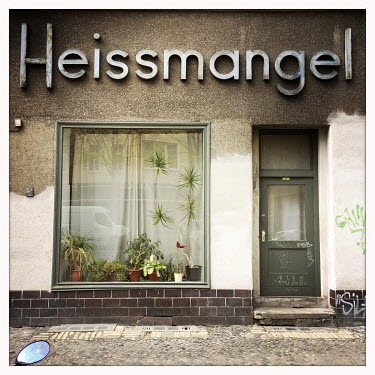 The facade of a closed shop called Heissmangel in Moabit.  The Berlin district of Moabit is an artificial island completely surrounded by water that was once home to various industries and staunchly w...