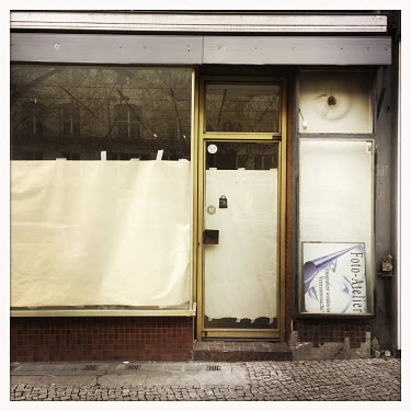 The exterior of a photographer's closed shop and studio.  The Berlin district of Moabit is an artificial island completely surrounded by water that was once home to various industries and staunchly wo...