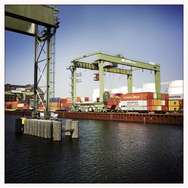 Shipping containers line a waterway in the Behala Westhafen industrial and harbour district.  The Berlin district of Moabit is an artificial island completely surrounded by water that was once home t...