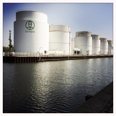 Storage tanks in the Behala Westhafen industrial and harbour district.  The Berlin district of Moabit is an artificial island completely surrounded by water that was once home to various industries a...