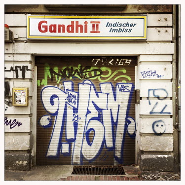 The facade of the shuttered Gandi Indian restaurant in Moabit.  The Berlin district of Moabit is an artificial island completely surrounded by water that was once home to various industries and staunc...