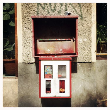 An old chewing gum machine in Moabit.  The Berlin district of Moabit is an artificial island completely surrounded by water that was once home to various industries and staunchly working-class . Howev...