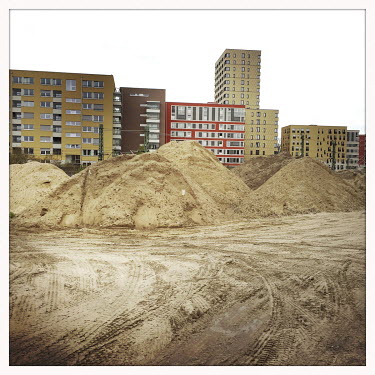 Building sand stored in a plot of land with a view towards new buildings at Lehrter Strasse.  The Berlin district of Moabit is an artificial island completely surrounded by water that was once home to...