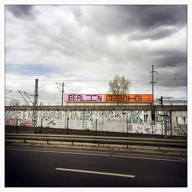 Railway tracks and an advertisment for Berlin Decks.  The Berlin district of Moabit is an artificial island completely surrounded by water that was once home to various industries and staunchly workin...