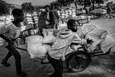 The monthly delivery of food from the World Food Programme (WFP). Food supplies have been disrupted by the COVID-19 pandemic and many displaced people living in unofficial settlements receive no aid.