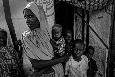 Hanwa holds her very malnourished 13-month-old daughter, Halima. Her husband was killed by insurgents in 2018 and she managed to escape from areas controlled by Boko Haram with her six children, who w...